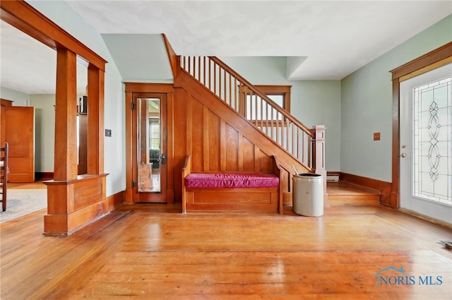 entryway with hardwood / wood-style flooring, stairs, and baseboards