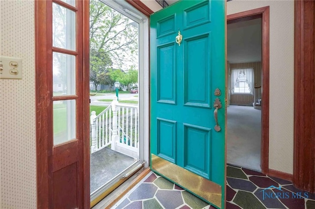 entryway featuring wallpapered walls