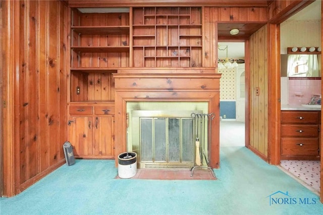 unfurnished living room with wood walls and carpet floors