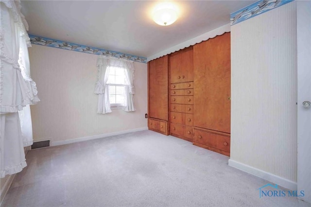unfurnished room featuring visible vents, baseboards, and carpet floors