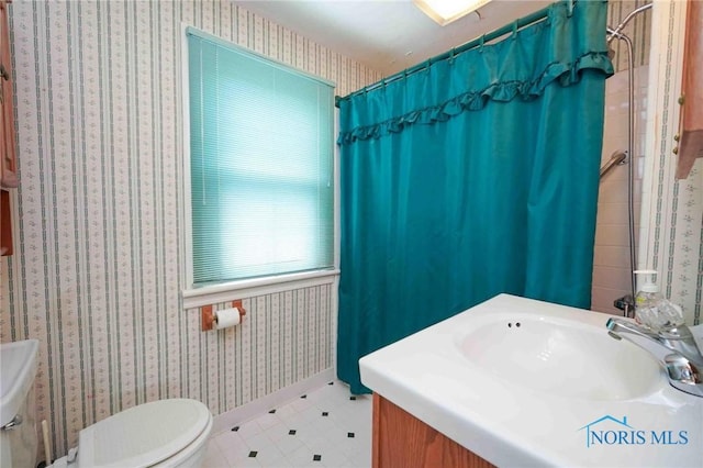 bathroom featuring a sink, tile patterned flooring, toilet, and a shower with shower curtain