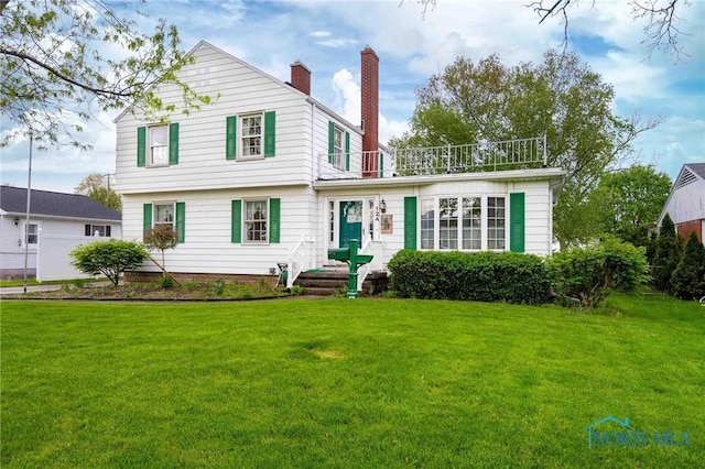 view of front facade featuring a chimney and a front yard