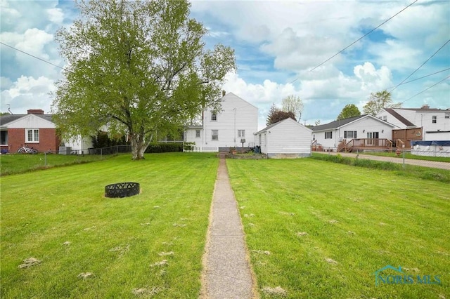 view of yard featuring fence and a residential view