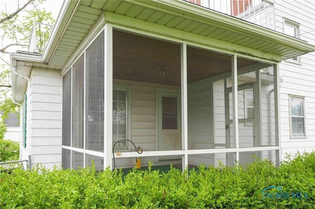 view of side of home featuring a sunroom