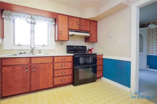 kitchen featuring a sink, wallpapered walls, black / electric stove, under cabinet range hood, and light countertops