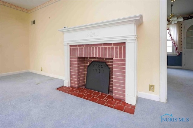 details with a brick fireplace, carpet flooring, baseboards, and visible vents