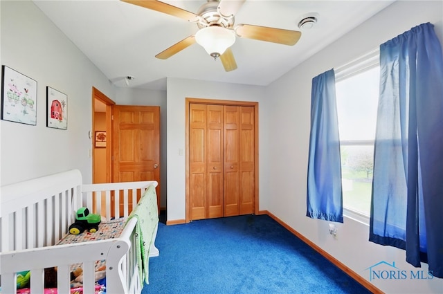bedroom featuring baseboards, multiple windows, and carpet flooring