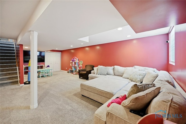 carpeted living area with stairs, baseboards, and recessed lighting