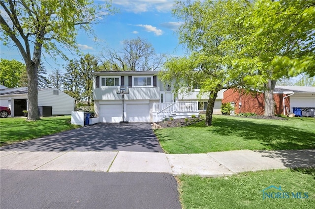 250 Southwood Dr, Perrysburg, OH 43551 - bi-level home featuring an attached garage, driveway, and a front lawn