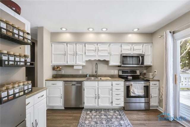 250 Southwood Dr, Perrysburg, OH 43551 - kitchen with dark wood-style floors, stainless steel appliances, white cabinets, and a sink