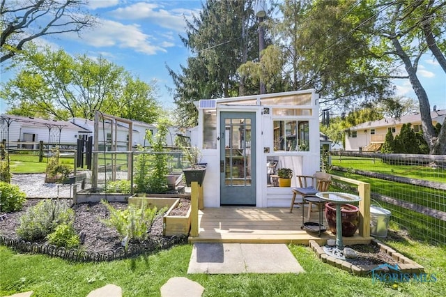250 Southwood Dr, Perrysburg, OH 43551 - view of outbuilding featuring fence, a vegetable garden, and an outdoor structure