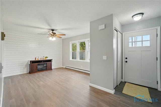 20161 Locust St, Weston, OH 43569 - foyer entrance with wood finished floors, a ceiling fan, plenty of natural light, and a baseboard heating unit