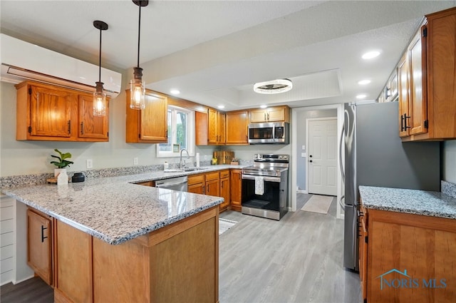20161 Locust St, Weston, OH 43569 - kitchen with a sink, a peninsula, brown cabinets, light wood-style flooring, and appliances with stainless steel finishes