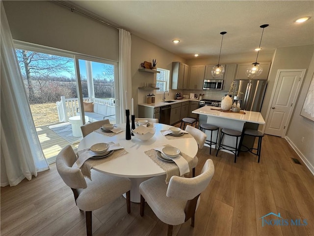 dining space with visible vents, recessed lighting, and wood finished floors
