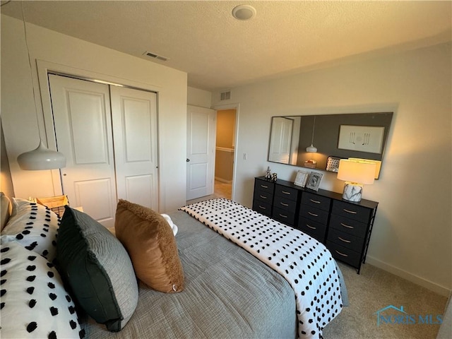 bedroom featuring light carpet, a closet, baseboards, and visible vents