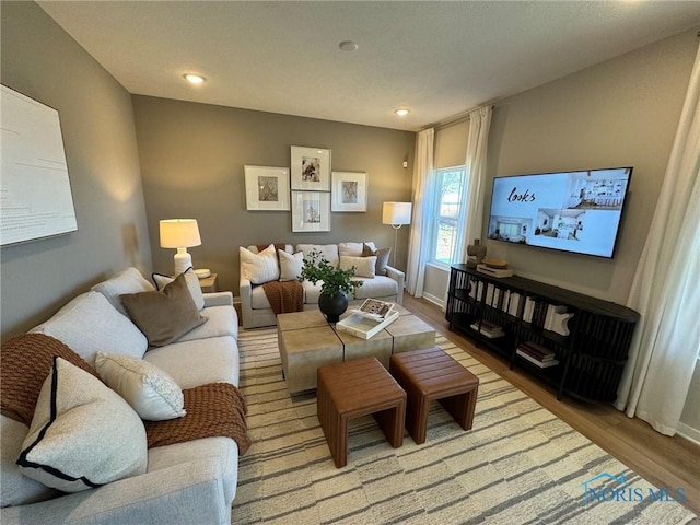 living area featuring baseboards, recessed lighting, and wood finished floors