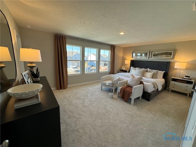 carpeted bedroom with baseboards, visible vents, and a textured ceiling