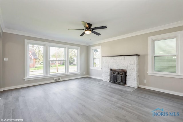 214 Meekison St, Napoleon, OH 43545 - unfurnished living room with ceiling fan, visible vents, baseboards, and ornamental molding