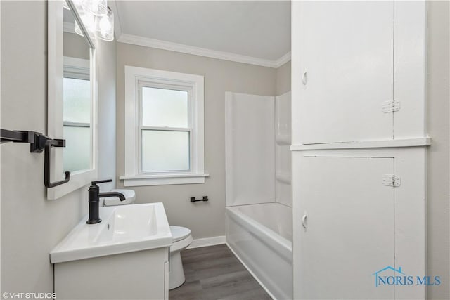 214 Meekison St, Napoleon, OH 43545 - full bath with toilet, baseboards, vanity, crown molding, and wood finished floors