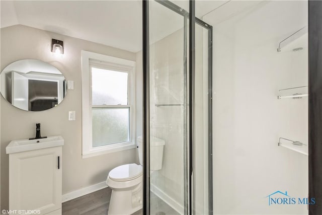 214 Meekison St, Napoleon, OH 43545 - full bathroom featuring a stall shower, a wealth of natural light, toilet, and wood finished floors