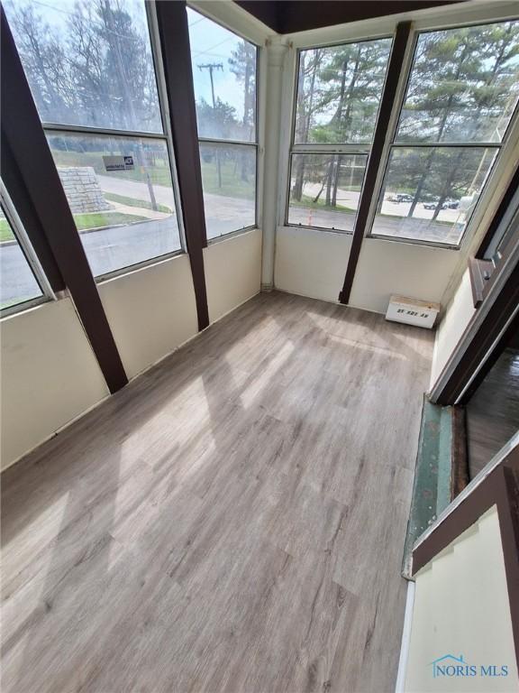 unfurnished sunroom with plenty of natural light