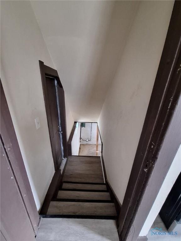 stairway featuring concrete floors