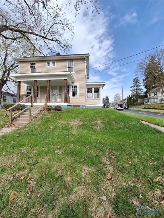 traditional home with a porch and a front yard