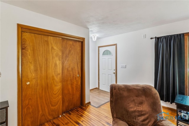 living area with light wood finished floors and baseboards