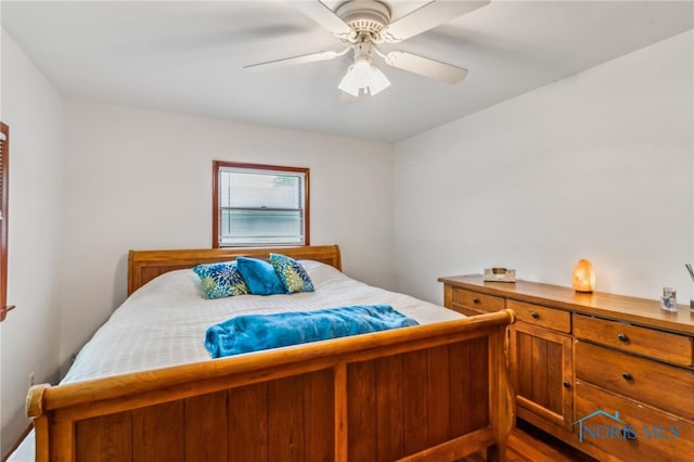 bedroom with dark wood finished floors and a ceiling fan