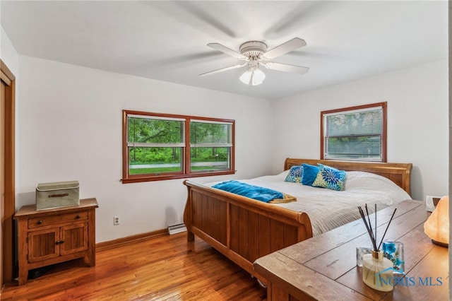 bedroom featuring light wood-style flooring, baseboards, and ceiling fan