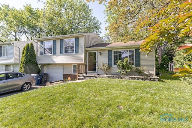 tri-level home with an attached garage, a front yard, and driveway