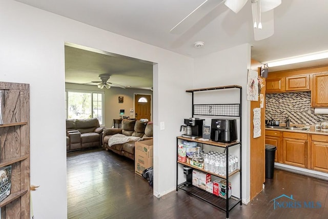 living room featuring a ceiling fan and dark wood finished floors