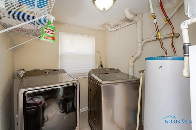 washroom with washer and clothes dryer and gas water heater