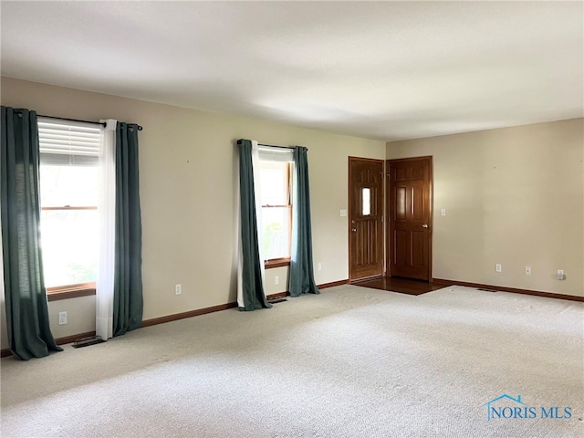 844 Sunset Dr, Findlay, OH 45840 - spare room featuring carpet and baseboards