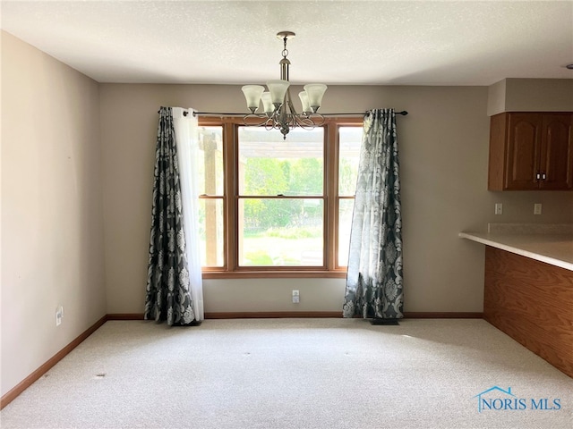 844 Sunset Dr, Findlay, OH 45840 - unfurnished dining area featuring a chandelier, light colored carpet, and baseboards
