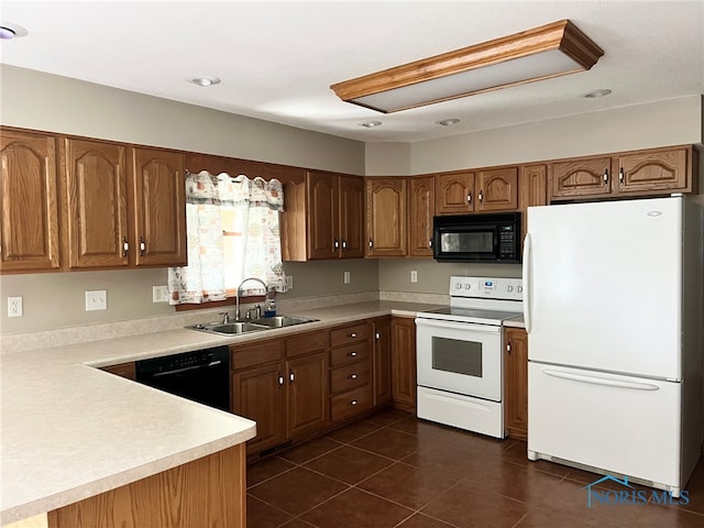 844 Sunset Dr, Findlay, OH 45840 - kitchen featuring black appliances, a sink, brown cabinetry, light countertops, and dark tile patterned floors