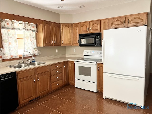 844 Sunset Dr, Findlay, OH 45840 - kitchen with black appliances, a sink, brown cabinets, and light countertops