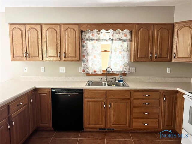 844 Sunset Dr, Findlay, OH 45840 - kitchen with black dishwasher, a sink, dark tile patterned floors, and light countertops
