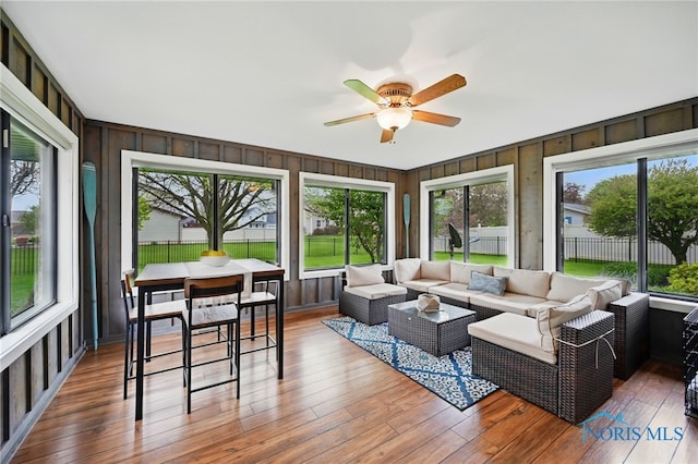 685 N Main St, Arlington, OH 45814 - sunroom / solarium featuring a deck, a ceiling fan, outdoor lounge area, wood finished floors, and wooden walls