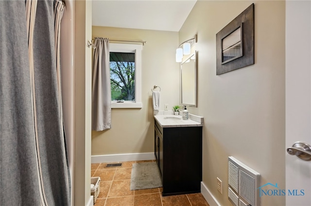 685 N Main St, Arlington, OH 45814 - full bathroom featuring vanity, tile patterned floors, baseboards, and heating unit