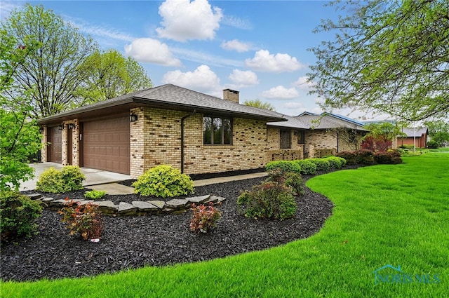685 N Main St, Arlington, OH 45814 - view of side of home featuring an attached garage, a lawn, a chimney, brick siding, and driveway