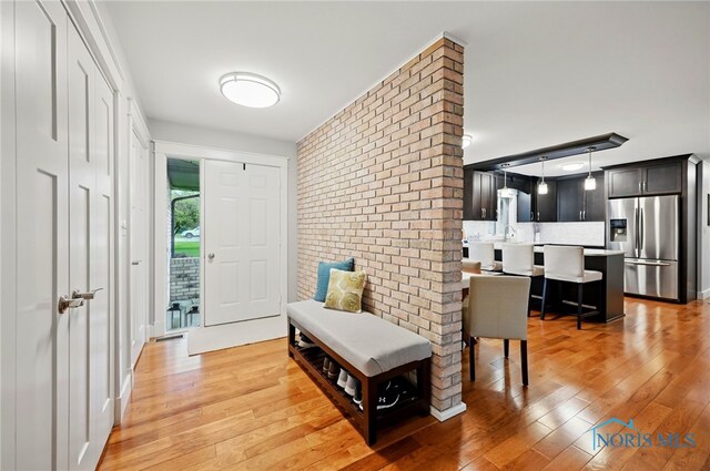 685 N Main St, Arlington, OH 45814 - entrance foyer featuring light wood-style floors and brick wall