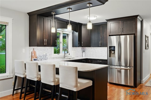 685 N Main St, Arlington, OH 45814 - kitchen featuring stainless steel fridge with ice dispenser, a sink, a peninsula, and plenty of natural light