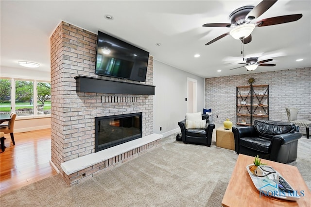 685 N Main St, Arlington, OH 45814 - living area featuring a fireplace, a ceiling fan, recessed lighting, baseboards, and brick wall