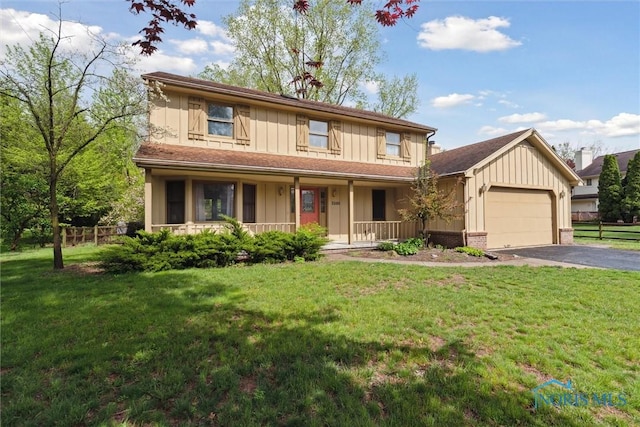 view of front of house featuring board and batten siding, a garage, covered porch, and driveway