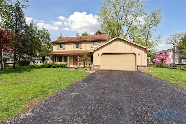 view of front facade featuring a garage, driveway, brick siding, a porch, and board and batten siding