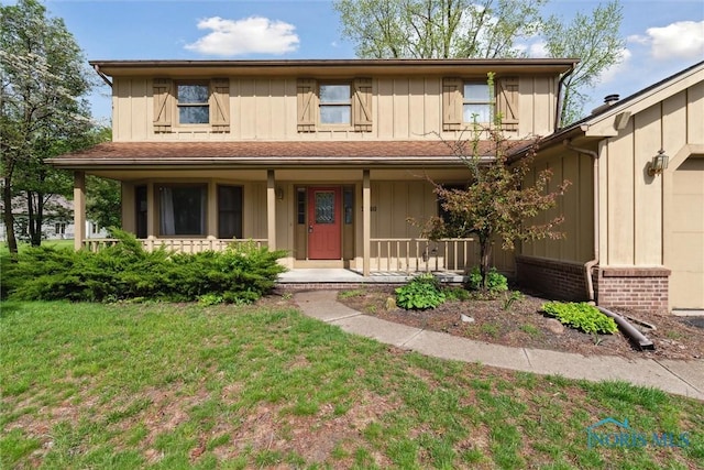 view of front of property featuring a porch, board and batten siding, and a front lawn