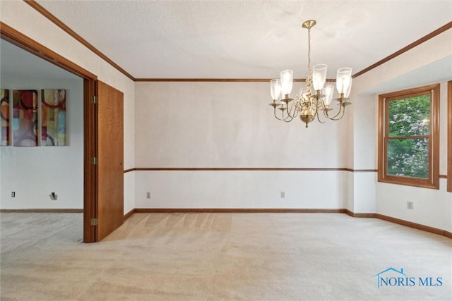 unfurnished room with carpet, a chandelier, crown molding, baseboards, and a textured ceiling