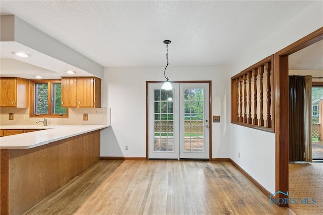 kitchen featuring light countertops, light wood-style flooring, healthy amount of natural light, and recessed lighting