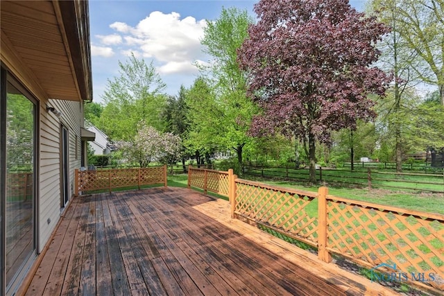 deck with a fenced backyard and view of scattered trees